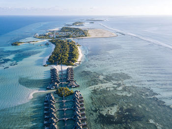 Maldives, kaafu atoll, aerial view of bungalows of tourist resort on huraa island