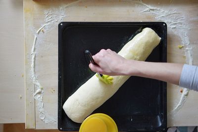 Directly above shot of cropped hand preparing food in kitchen at home