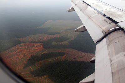 Aerial view of landscape seen through airplane window