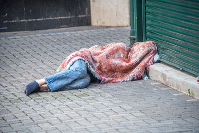 Man sleeping on footpath