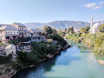 River in town against clear sky