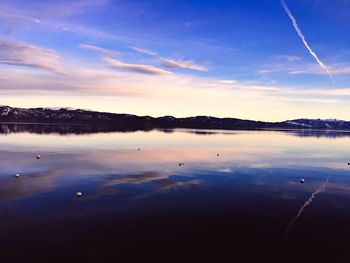 Scenic view of lake against cloudy sky