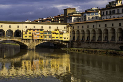 Tourists in ponte vecchio over arno river - florence, tuscany, italy