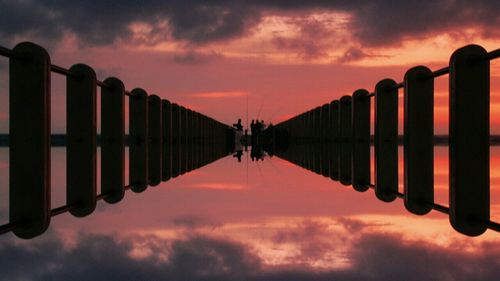 Built structure against cloudy sky at sunset