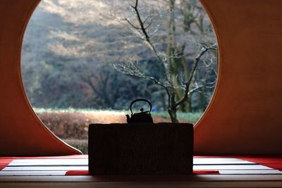 Silhouette kettle on table in temple