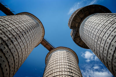 Low angle view of buildings against cloudy sky