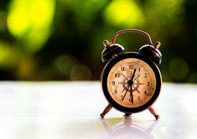 Close-up of clock on table
