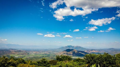 Scenic view of landscape against blue sky