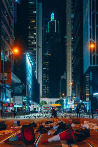 Illuminated city street and buildings at night