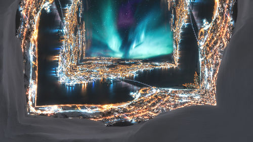 Aerial view of illuminated city buildings at night