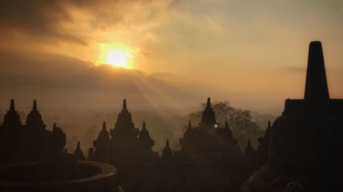 Panoramic view of buildings against sky during sunset