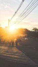 Cars on street in city at sunset