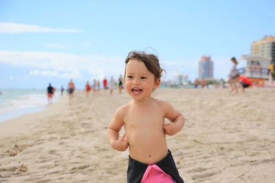 Portrait of smiling girl standing on beach