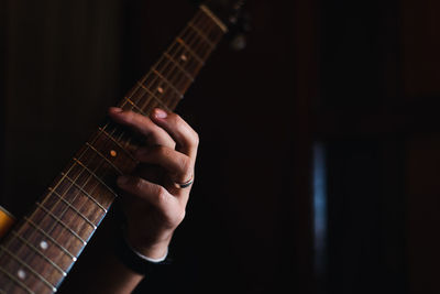 Close-up of person playing guitar