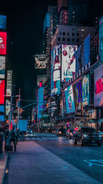 Illuminated city street and buildings at night