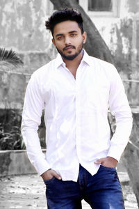 Portrait of young man standing at beach