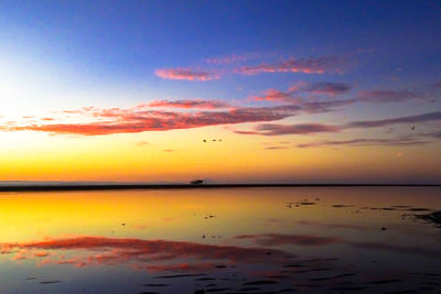 Scenic view of sea against romantic sky at sunset