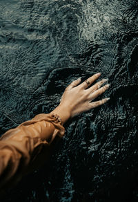 Low section of woman legs in water