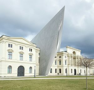 Low angle view of built structure against cloudy sky