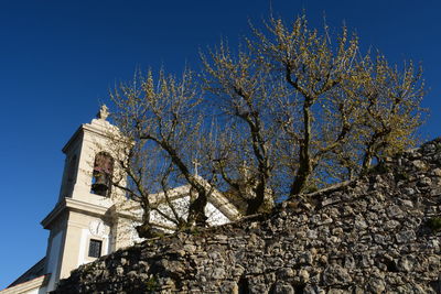 Low angle view of clock tower against clear sky