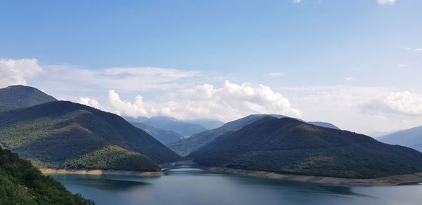 Scenic view of lake and mountains against sky