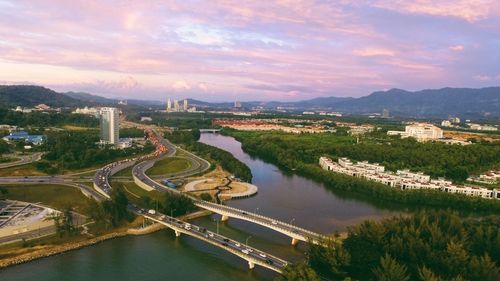 High angle view of river amidst city against sky