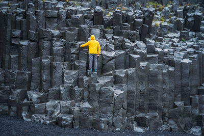 Rear view of man walking on rock