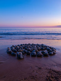 Stone circle at low tide on a sandy beach at  sunset
