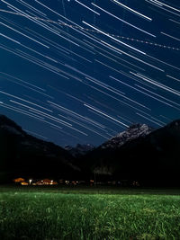 Scenic view of field against sky at night