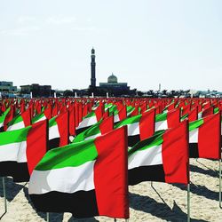 View of united arab emirates flags at beach against the sky