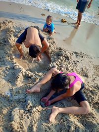 High angle view of friends on beach