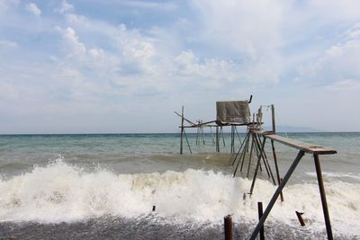 Lifeguard hut on beach against sky