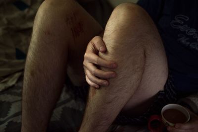 Low section of man sitting outdoors