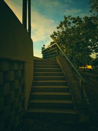 Low angle view of staircase by building against sky