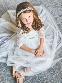 High angle portrait of cute girl siting at home