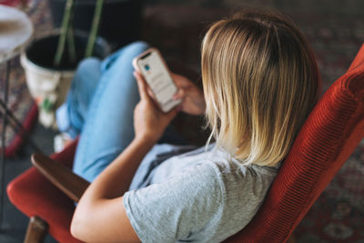 Midsection of woman using mobile phone