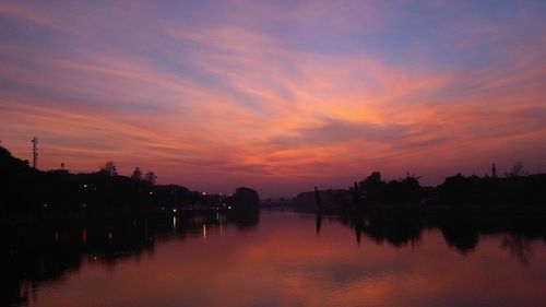 Scenic view of lake against romantic sky at sunset