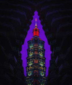 Low angle view of illuminated buildings at night