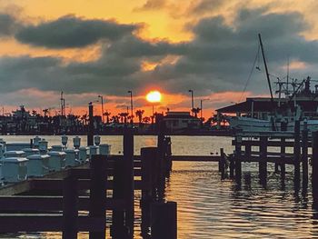 Boats at harbor during sunset