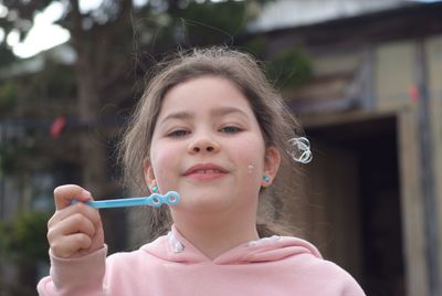 Close-up portrait of a teenage girl with bubbles