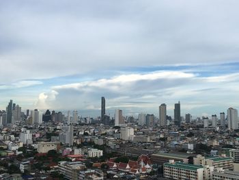 Aerial view of modern buildings in city against sky