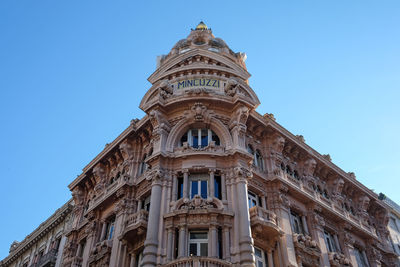 Low angle view of building against clear blue sky