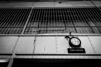 Low angle view of clock on wall