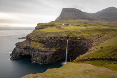 Scenic view of sea and rock formation against sky