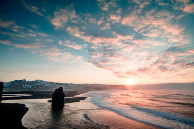 Scenic view of sea against sky during sunset iconic basaltic beach at sunrise warm atmosphere 