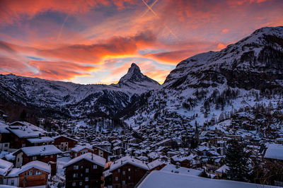 Scenic view of snowcapped mountains against sky during sunset