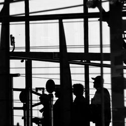 Silhouette people standing against sky