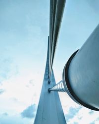 Metallic cables on bridge against sky