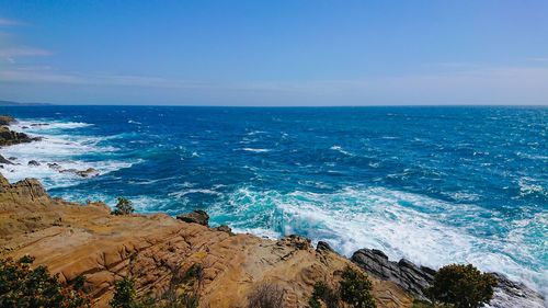 Scenic view of sea against blue sky