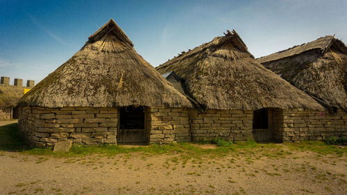 Old building on field against sky